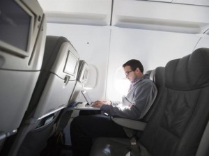 man using laptop on plane reuters